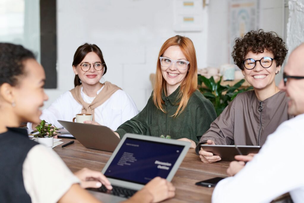 Diverse group of professionals sitting together in a meeting, representing international workers seeking jobs in Germany