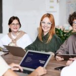 Diverse group of professionals sitting together in a meeting, representing international workers seeking jobs in Germany