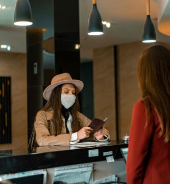 Woman standing in a hotel, representing seasonal jobs in hotels and resorts without experience