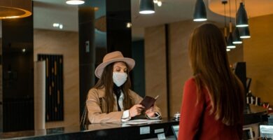Woman standing in a hotel, representing seasonal jobs in hotels and resorts without experience